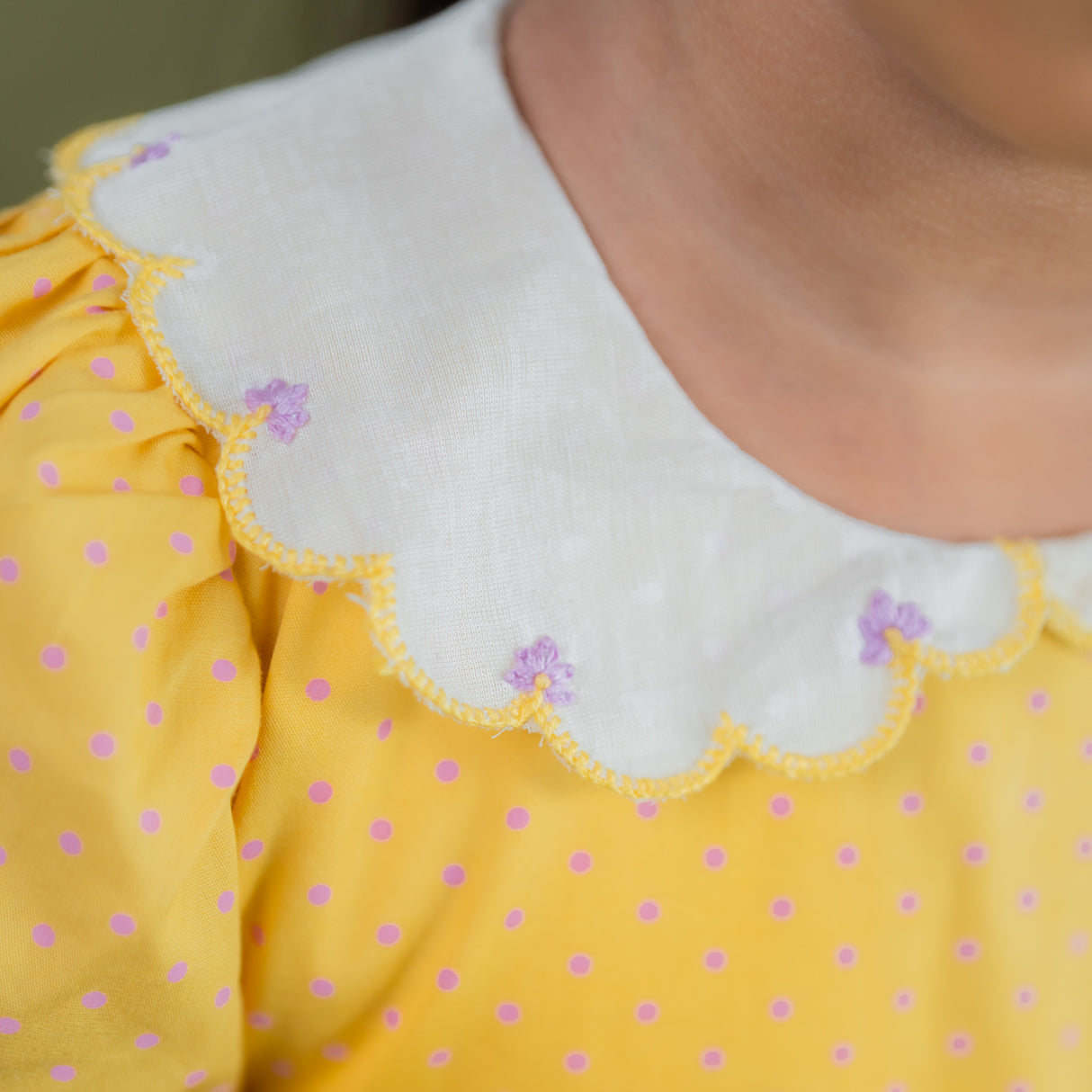 closeup of the embroidery detail in the scallop collar