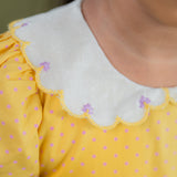closeup of the embroidery detail in the scallop collar