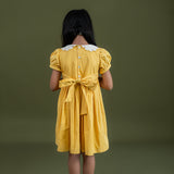 backview of the mustard dot print dress