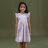 a little girl dressed in pink dot print dress