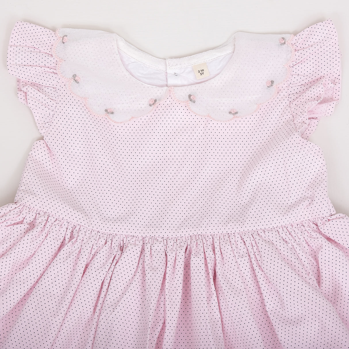 closeup of the embroidery detail in the scallop collar