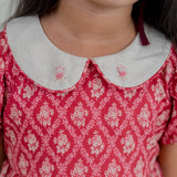 closeup of the mebroidery detail on peter pam collar of the red vintage rose print dress