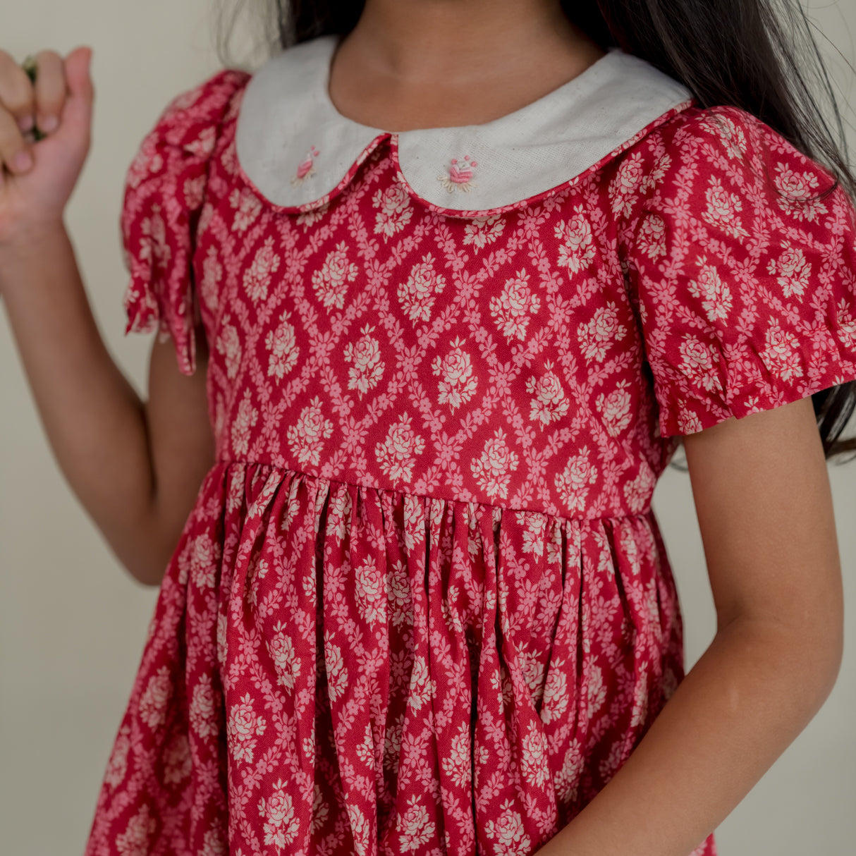 side closeup view of the bodice of the red vintage rose print dress