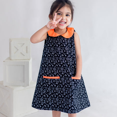 a little girl dressed in black science print a line dress
