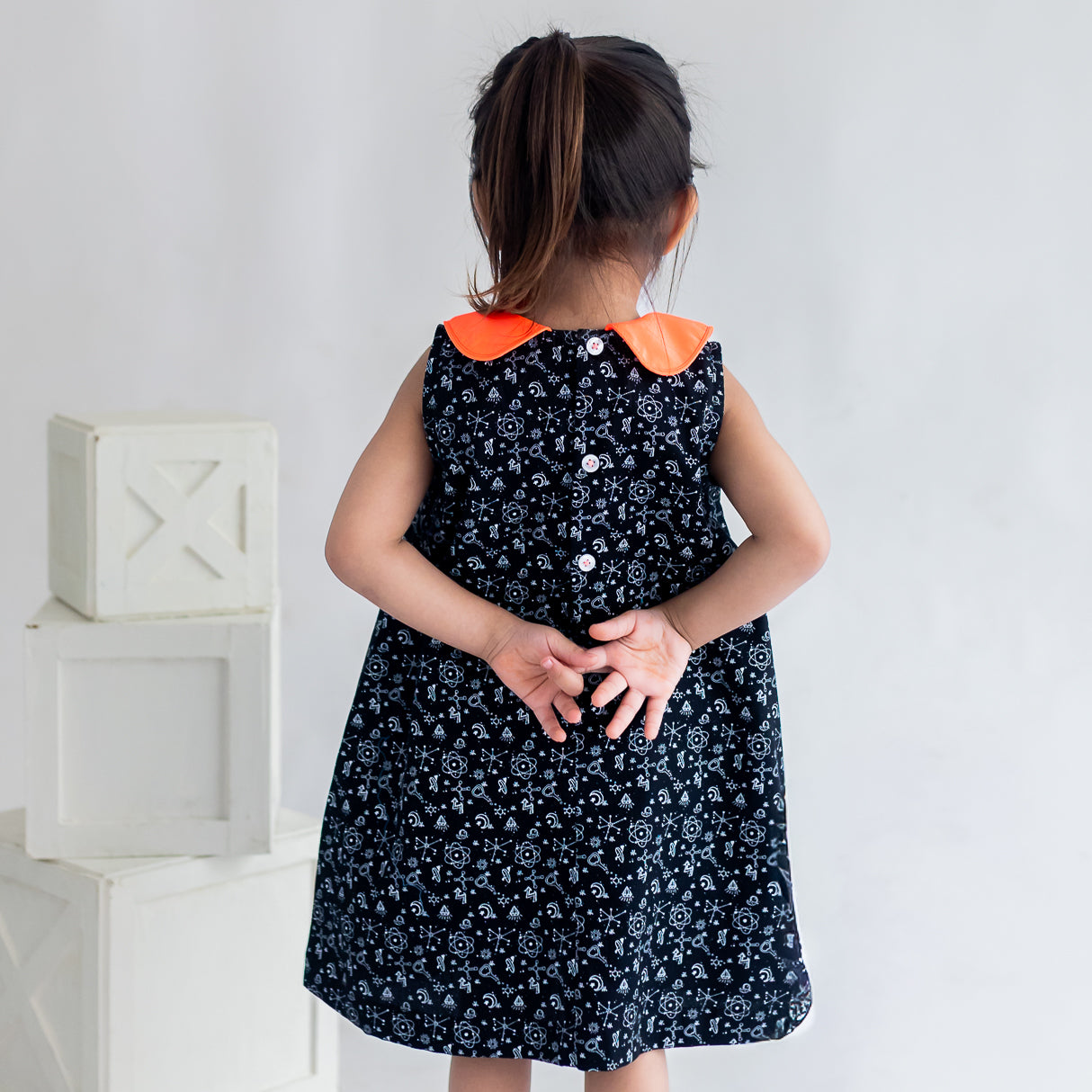 closeup of back buttons of the black science print a line dress