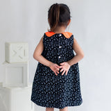 closeup of back buttons of the black science print a line dress
