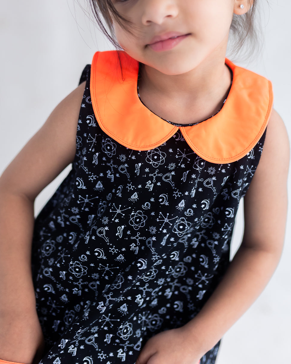 closeup of neon orange collar of the  black science print a line dress