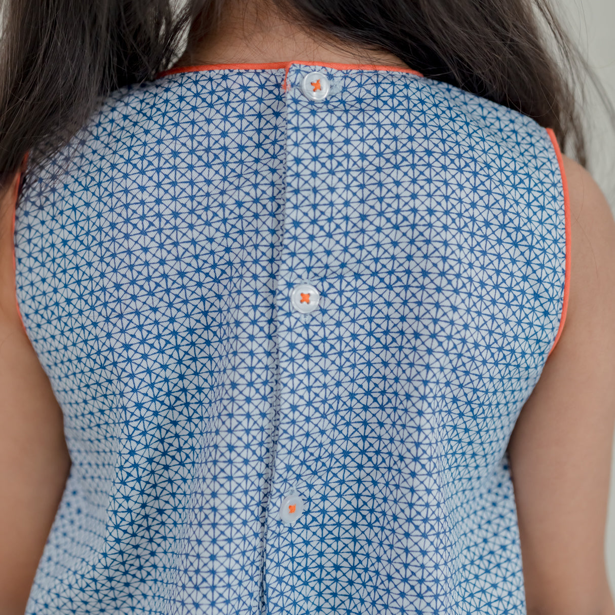 closeup of the back button detail of the blue print a line dress