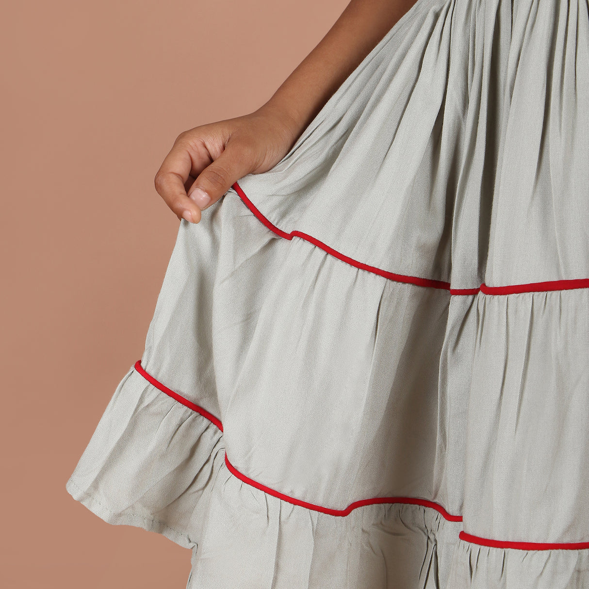 close-up of layered tiered skirt with red contrast piping