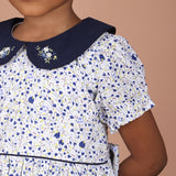 close-up of navy blue peter pan collar with floral hand embroidery