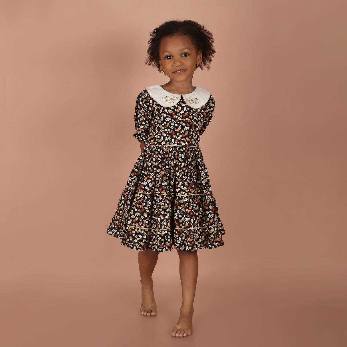 full  view of black floral hand-embroidered layered girls dress