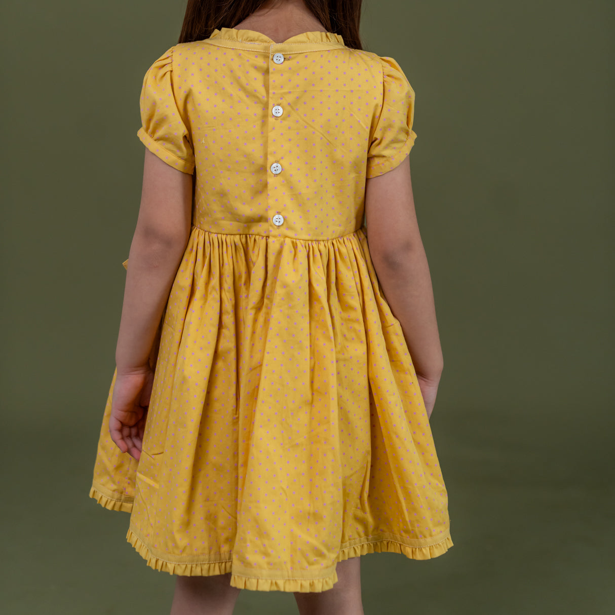 back view of mustard crossover dress