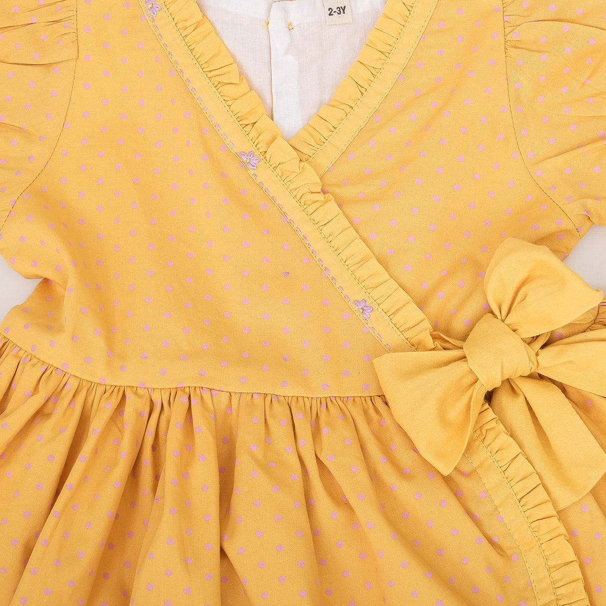 closeup of embroidery and bow detail