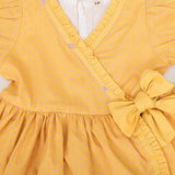 closeup of embroidery and bow detail