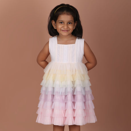 Front view of girls light pink rainbow layered tulle party dress with sleeveless design