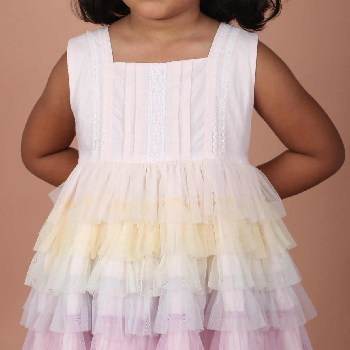 Close-up of pleated bodice and rainbow layered skirt detailing on girls dress