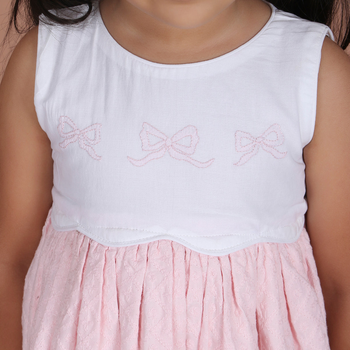 close-up of shadow bow embroidery on bodice