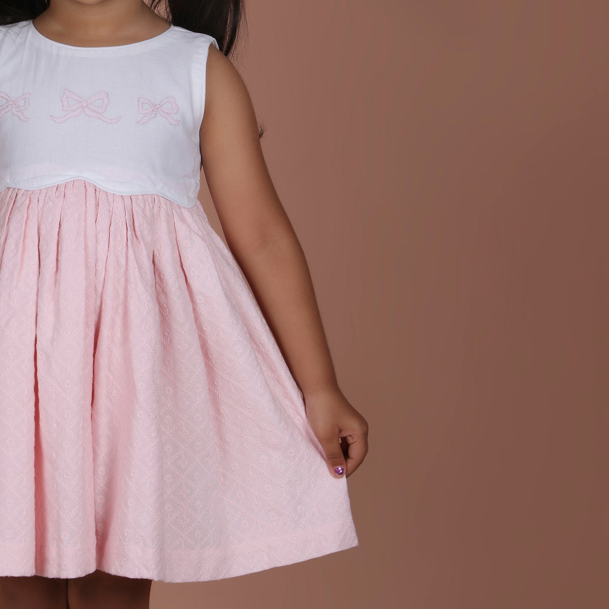 front view showing scallop waistline and schiffli skirt