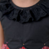 closeup of the lace detail in neckline of the black scallop bodice dress