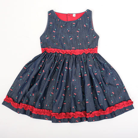 Front view of girls denim cherry print dress with red ruffle detailing