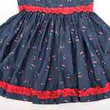 Detailed waist and skirt ruffle view of girls cherry print denim dress