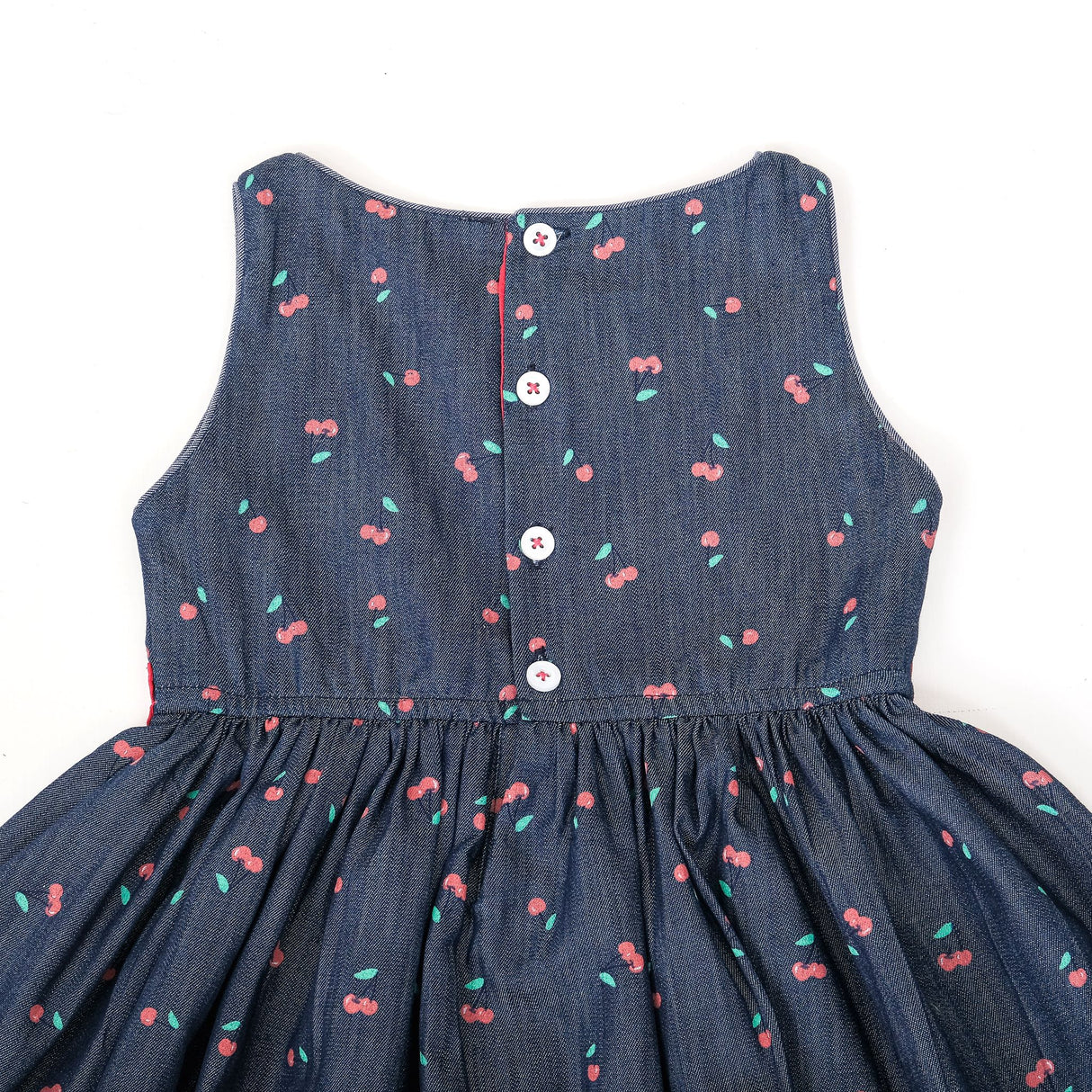 Back view of denim cherry dress with button closure