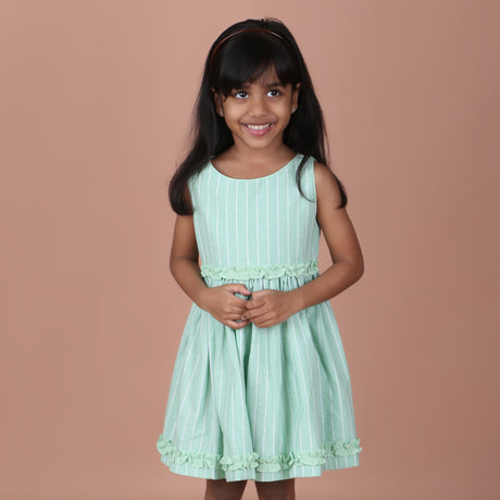 Front view of mint green sleeveless striped dress with ruffle details
