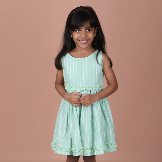Front view of mint green sleeveless striped dress with ruffle details