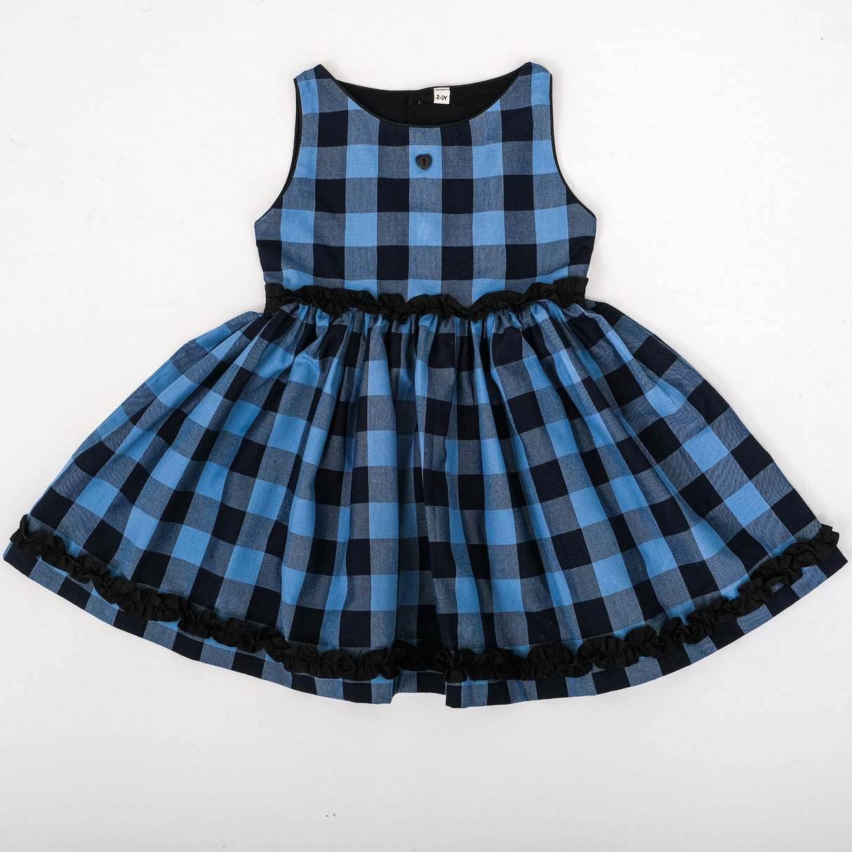 Front view of blue and black check with ruffle detailings