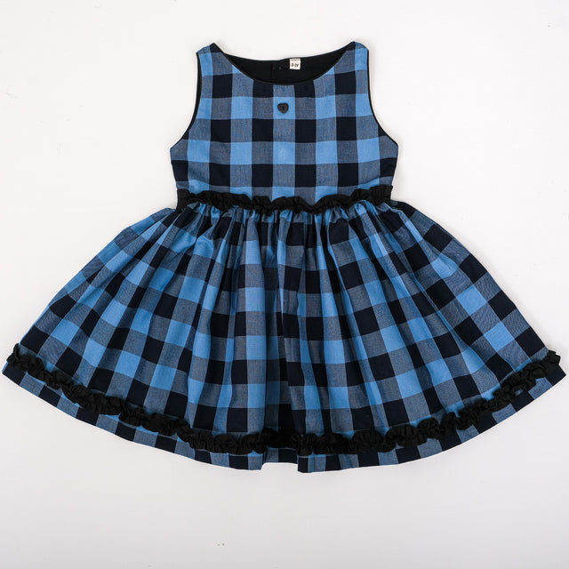 Front view of blue and black check with ruffle detailings