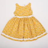 flat lay of yellow floral dress with ruffle detail