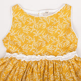 close-up of neckline piping and ruffle waist detail