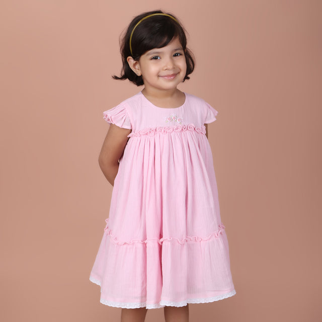 girl wearing candy pink dress with rose embroidery