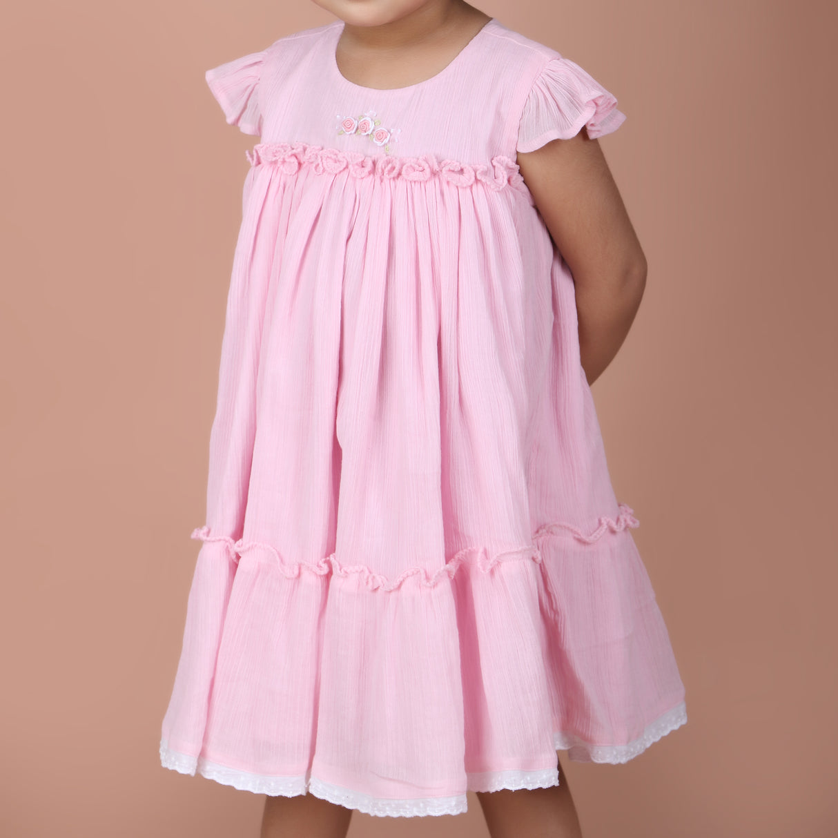 front view showing ruffle details and lace trim hem