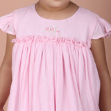 close-up of rose embroidery with picot ruffle detail