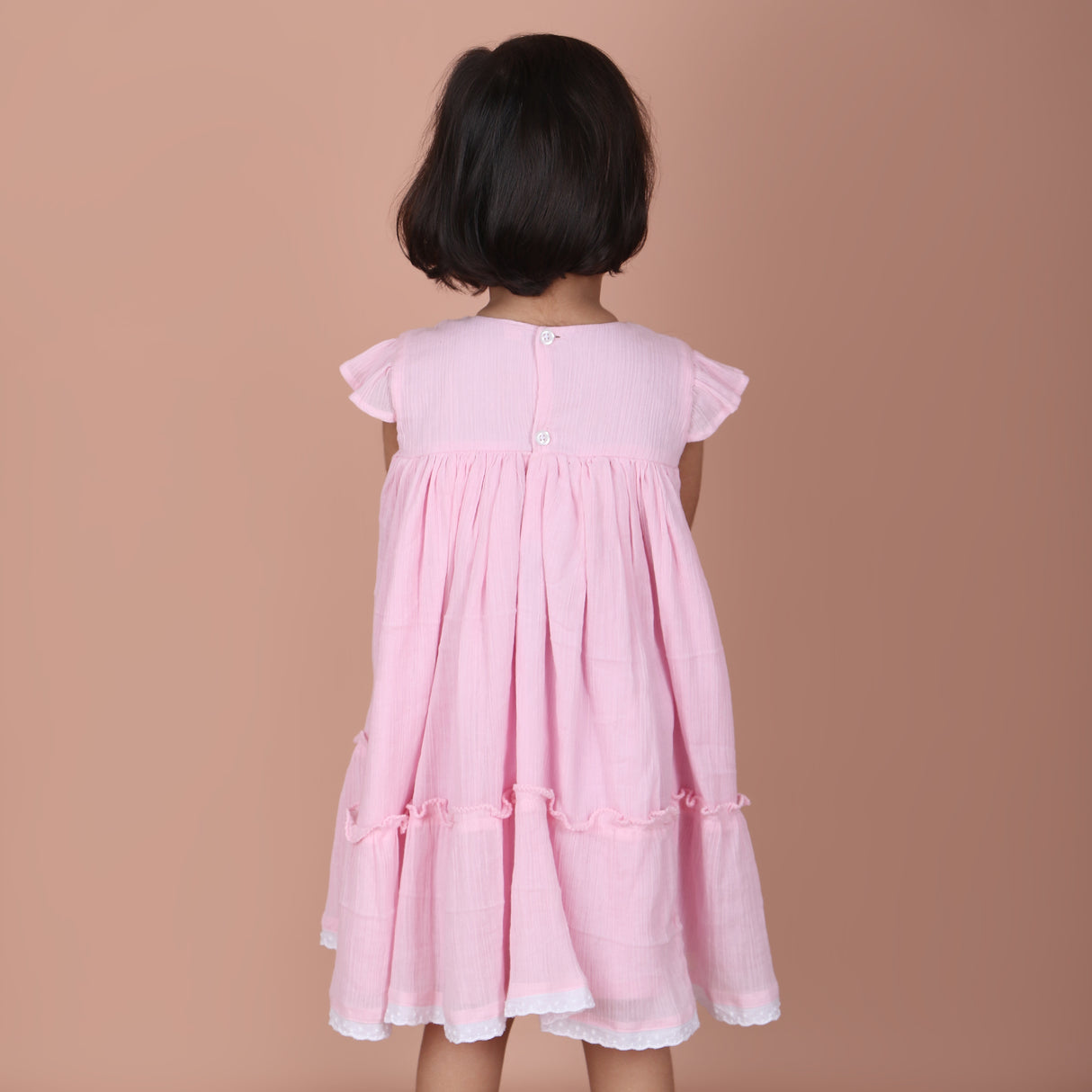 back view showing button closure and elastic detail