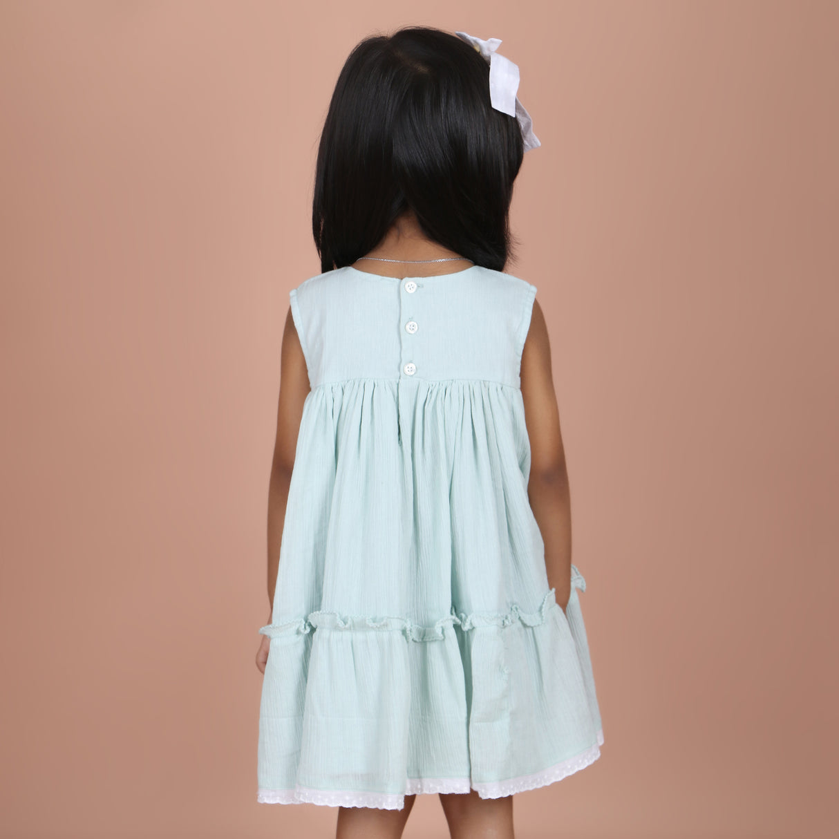 back view showing button closure and elastic detail