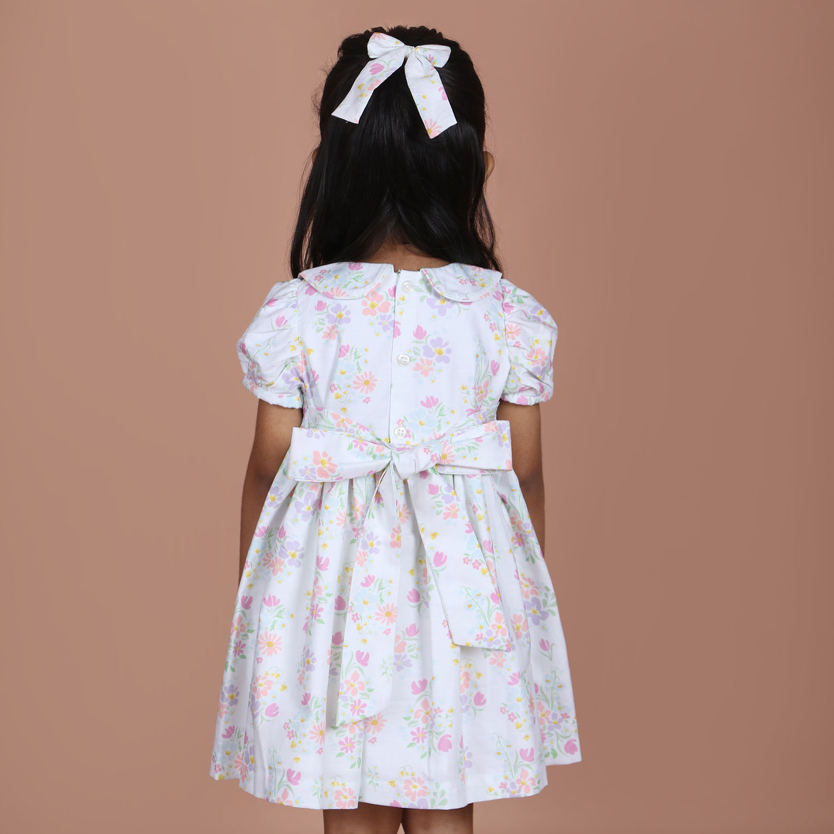 back view showing button closure and waist ties