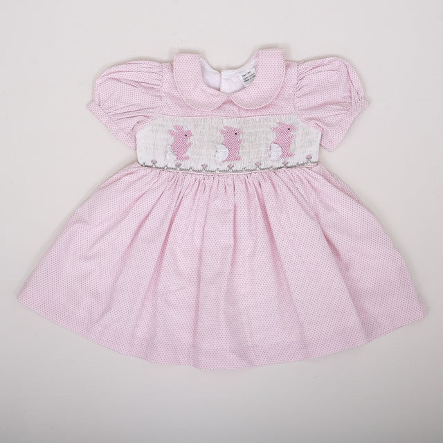 flat lay of pale pink micro dot dress with bunny embroidery