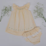 Front flat lay view of yellow hand smocked baby dress with matching bloomers