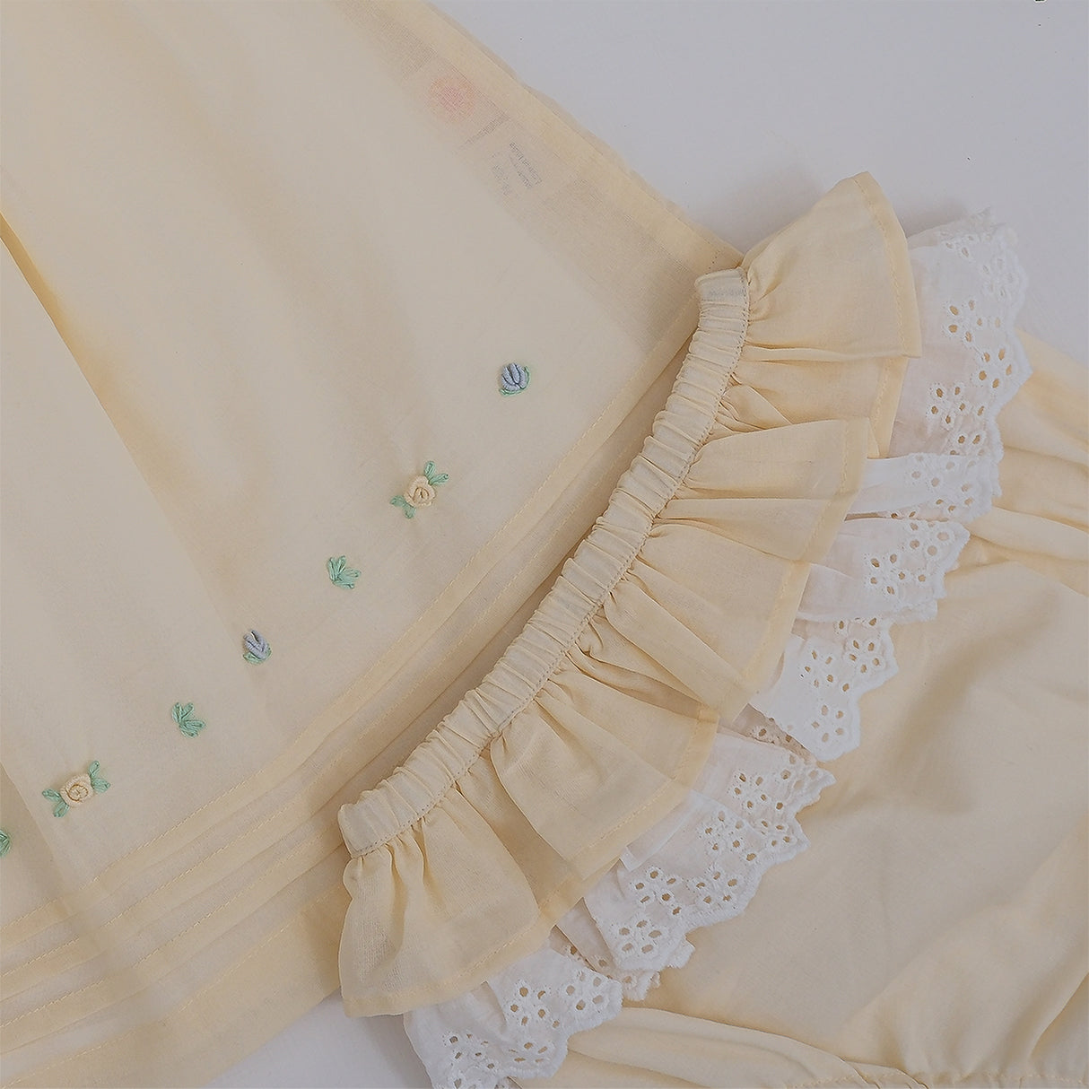 Yellow baby dress with gathered skirt and embroidered detailing