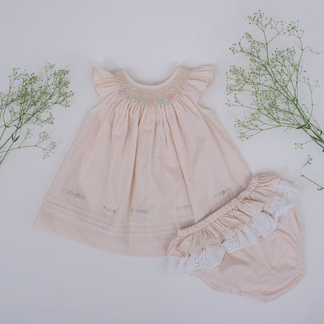 Front flat lay view of tan hand smocked flutter sleeve girls dress with bloomer