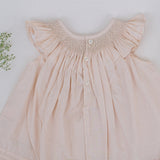 Back view of tan smocked dress with button closure