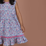 closeup of hem detailing on blue floral girls dress