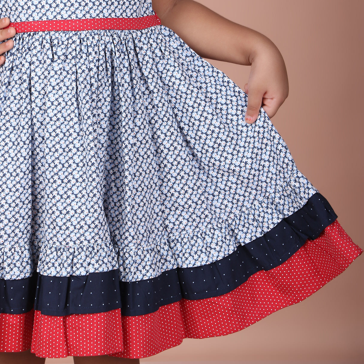 closeup of the skirt hem showing ditsy floral pattern with navy and red border detail