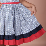 closeup of the skirt hem showing ditsy floral pattern with navy and red border detail