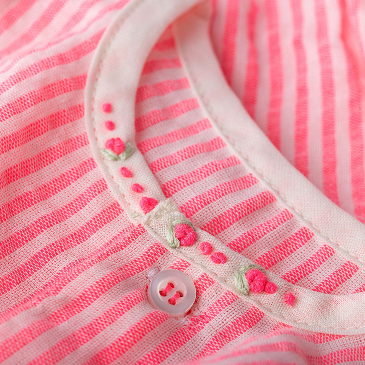 neon stripe onesie close up with neon hand embroidered roses