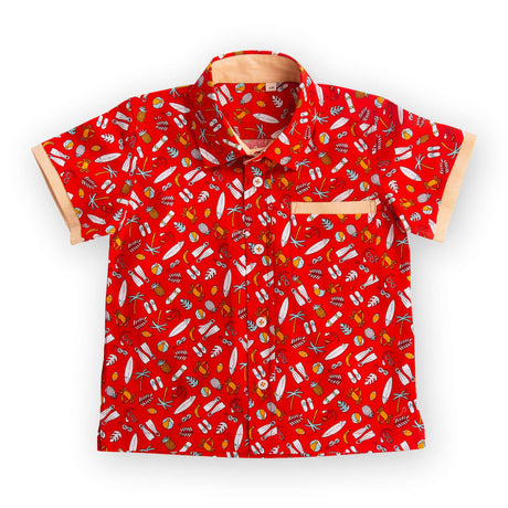 Flatlay of red printed shirt with coordinated fabric bands stitched underneath the pocket and sleeve hems