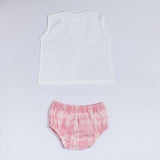 Flatlay of jabla with hand embroidered flower and bee with pin tuck detail and pink plaid bloomers