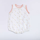 Flatlay of star print onesie with neon pink stripe piping, front open placket and button fastening